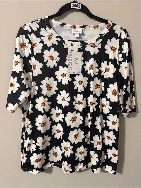 LuLaRoe Tops - LuLaRoe Black Short Sleeve Tee with White and Golden Daisy Print
